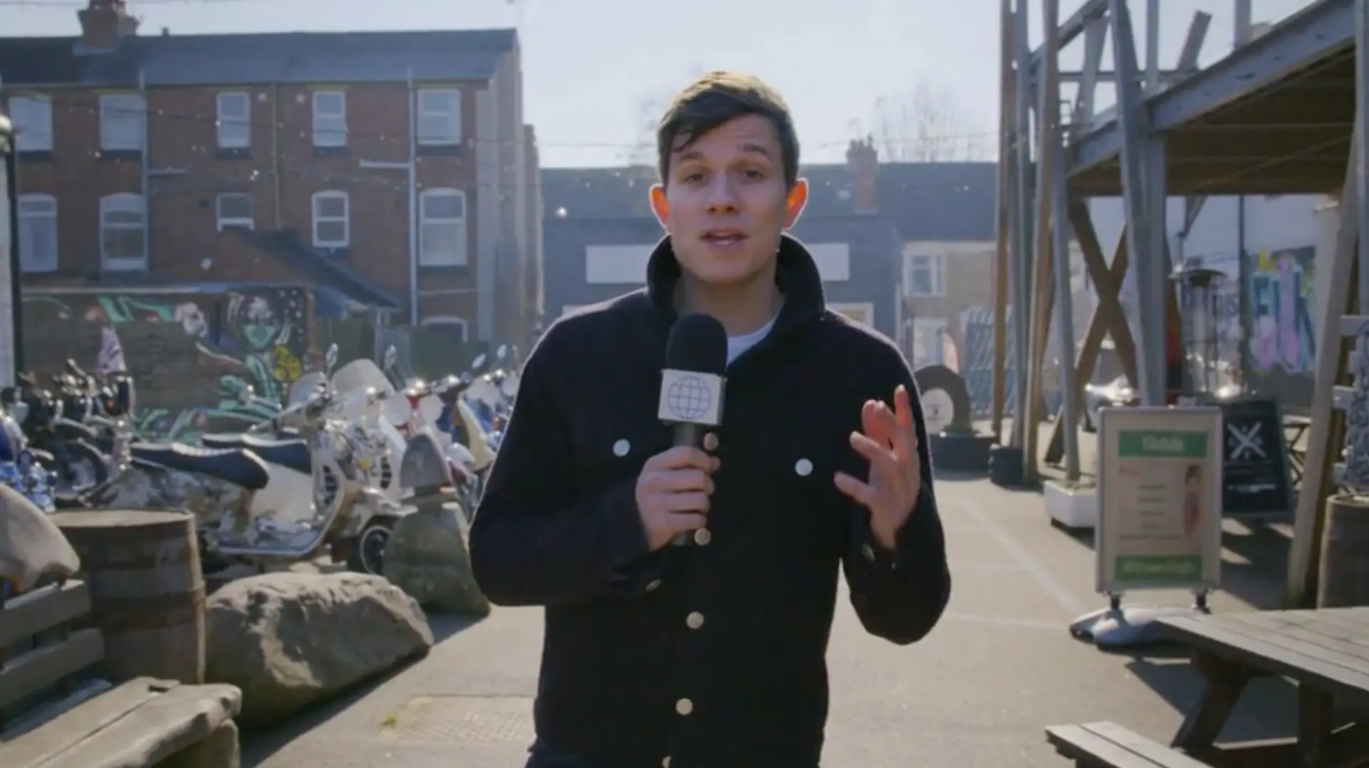 Will Best presenting to camera with a microphone while filming on location